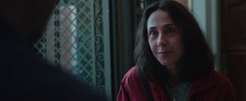 Movie still from “Rose” (2022), directed by Niels Arden Oplev – A person wearing a red shirt; Close Up shot, Over the shoulder angle