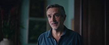 Movie still from “Rose” (2022), directed by Niels Arden Oplev – A person wearing a blue shirt; Close Up shot, Over the shoulder angle