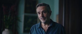 Movie still from “Rose” (2022), directed by Niels Arden Oplev – A person wearing a blue shirt; Close Up shot, Over the shoulder angle