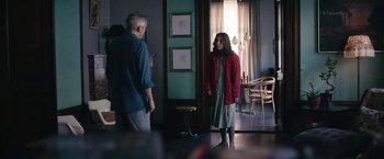 Movie still from “Rose” (2022), directed by Niels Arden Oplev – A man and a woman standing in front of a window; Wide shot, Over the shoulder angle