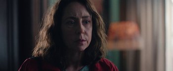 Movie still from “Rose” (2022), directed by Niels Arden Oplev – A person wearing a red jacket; Close Up shot, Over the shoulder angle