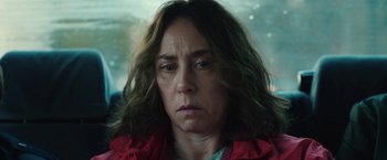 Movie still from “Rose” (2022), directed by Niels Arden Oplev – A person with long hair; Close Up shot, Over the shoulder angle