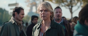 Movie still from “Rose” (2022), directed by Niels Arden Oplev – A woman with blonde hair wearing a green jacket; Close Up shot, Over the shoulder angle