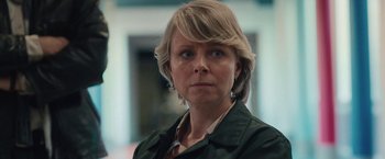 Movie still from “Rose” (2022), directed by Niels Arden Oplev – A person with short hair; Close Up shot, Low angle