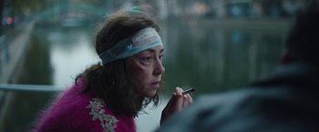 Movie still from “Rose” (2022), directed by Niels Arden Oplev – A woman with a bandage on her head smoking a cigarette; Close Up shot, Over the shoulder angle
