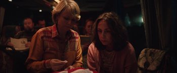 Movie still from “Rose” (2022), directed by Niels Arden Oplev – Two women sitting at a table looking at a piece of paper; Close Up shot, High angle