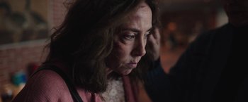 Movie still from “Rose” (2022), directed by Niels Arden Oplev – A person with a bruise on their face; Close Up shot, Over the shoulder angle