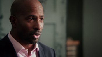 Movie still from “13th” (2016), directed by Ava DuVernay – A person wearing a suit and tie; Close Up shot, Over the shoulder angle