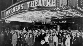 Movie still from “13th” (2016), directed by Ava DuVernay – A group of people standing in front of a theater; Wide shot, High angle