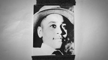 Movie still from “13th” (2016), directed by Ava DuVernay – A black and white photo of a young man wearing a hat; Extreme Close Up shot, Overhead angle