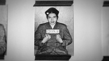 Movie still from “13th” (2016), directed by Ava DuVernay – An old black and white photo of a woman holding up a plate; Medium shot, Overhead angle