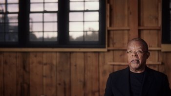 Movie still from “13th” (2016), directed by Ava DuVernay – An older man in a black suit sitting in front of a window; Close Up shot, Over the shoulder angle