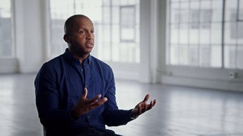 Movie still from “13th” (2016), directed by Ava DuVernay – A man in a blue shirt is talking to someone; Close Up shot, Low angle