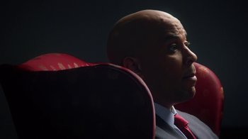 Movie still from “13th” (2016), directed by Ava DuVernay – A man in a suit and tie sitting in a chair; Close Up shot, Low angle