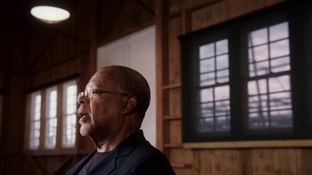 Movie still from “13th” (2016), directed by Ava DuVernay – An older black man wearing glasses and a jacket; Close Up shot, Low angle