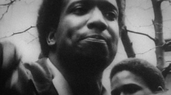 Movie still from “13th” (2016), directed by Ava DuVernay – A black - and - white photo of a man with a microphone; Close Up shot, Low angle