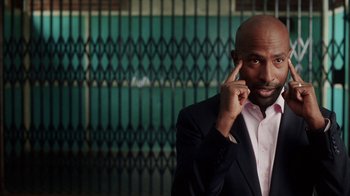 Movie still from “13th” (2016), directed by Ava DuVernay – A man in a suit talking on a cell phone; Close Up shot, High angle