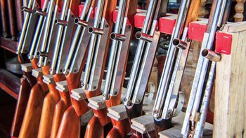 Movie still from “13th” (2016), directed by Ava DuVernay – A bunch of guns that are lined up together; Extreme Close Up shot, Overhead angle