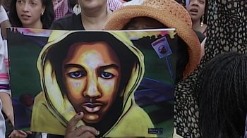 Movie still from “13th” (2016), directed by Ava DuVernay – A woman holding a painting of a man; Extreme Close Up shot, High angle