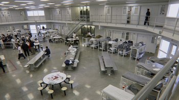 Movie still from “13th” (2016), directed by Ava DuVernay – People sitting at tables in a large room; Extreme Wide shot, High angle