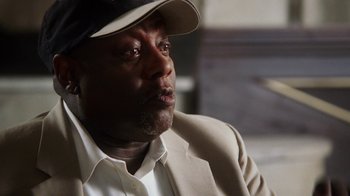 Movie still from “13th” (2016), directed by Ava DuVernay – A person wearing a hat; Close Up shot, High angle