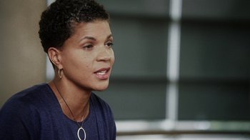 Movie still from “13th” (2016), directed by Ava DuVernay – A person wearing a blue shirt; Close Up shot, High angle