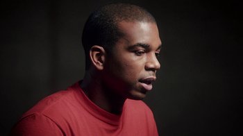 Movie still from “13th” (2016), directed by Ava DuVernay – A person wearing a red t - shirt; Close Up shot, Low angle