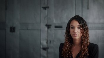 Movie still from “13th” (2016), directed by Ava DuVernay – A beautiful young woman with long curly brown hair; Close Up shot, Low angle
