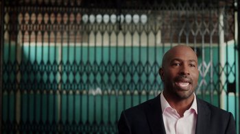 Movie still from “13th” (2016), directed by Ava DuVernay – A man standing in front of a metal gate; Close Up shot, Over the shoulder angle