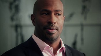 Movie still from “13th” (2016), directed by Ava DuVernay – A man in a suit and pink shirt; Close Up shot, Over the shoulder angle