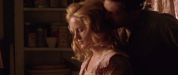 Movie still from “Rosewood” (1997), directed by John Singleton – A woman with long blonde hair and a man with long blonde hair; Close Up shot, Low angle