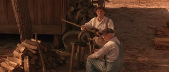 Movie still from “Rosewood” (1997), directed by John Singleton – A couple of people that are working on something; Wide shot, High angle