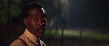 Movie still from “Rosewood” (1997), directed by John Singleton – A black man with a mustache and a tie; Close Up shot, Low angle
