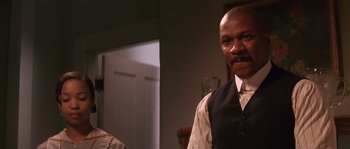 Movie still from “Rosewood” (1997), directed by John Singleton – A man standing in front of a mirror; Close Up shot, Low angle