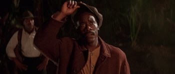 Movie still from “Rosewood” (1997), directed by John Singleton – A man in a brown jacket and a brown hat; Close Up shot, Low angle