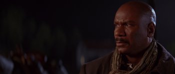 Movie still from “Rosewood” (1997), directed by John Singleton – A man with a beard is looking to his left; Close Up shot, Over the shoulder angle