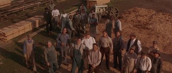 Movie still from “Rosewood” (1997), directed by John Singleton – A group of men standing next to each other on top of a hill; Wide shot, High angle