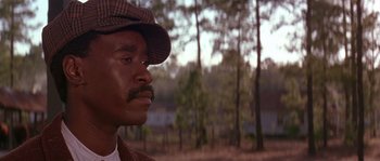 Movie still from “Rosewood” (1997), directed by John Singleton – A man with a hat and a beard looking to his left; Close Up shot, Low angle
