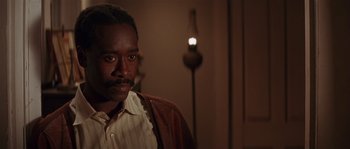 Movie still from “Rosewood” (1997), directed by John Singleton – A man in a brown jacket is looking at the camera; Close Up shot, Over the shoulder angle