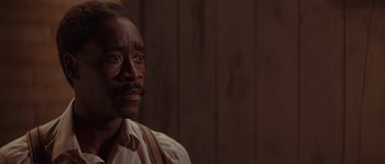 Movie still from “Rosewood” (1997), directed by John Singleton – An older man with a mustache is looking at the camera; Close Up shot, Over the shoulder angle