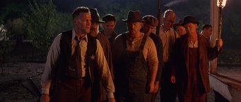 Movie still from “Rosewood” (1997), directed by John Singleton – A group of men standing next to each other; Medium shot, Low angle