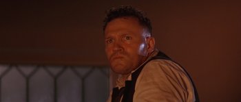 Movie still from “Rosewood” (1997), directed by John Singleton – A person wearing a suit and tie; Close Up shot, Low angle