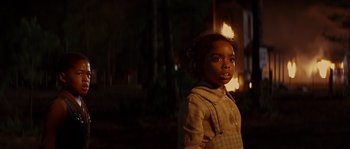 Movie still from “Rosewood” (1997), directed by John Singleton – A little girl standing in front of a fire; Close Up shot, Over the shoulder angle