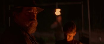 Movie still from “Rosewood” (1997), directed by John Singleton – A man with a beard wearing a hat; Close Up shot, Over the shoulder angle