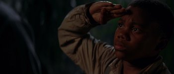 Movie still from “Rosewood” (1997), directed by John Singleton – A man is holding his hand up to his forehead; Close Up shot, Low angle
