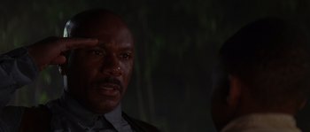 Movie still from “Rosewood” (1997), directed by John Singleton – A person wearing a suit and tie; Close Up shot, Low angle