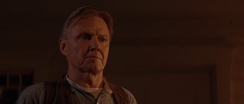 Movie still from “Rosewood” (1997), directed by John Singleton – An older man in a brown vest looking at the camera; Close Up shot, Low angle