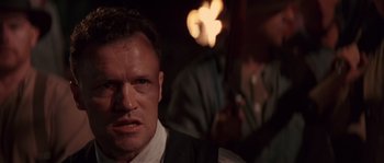 Movie still from “Rosewood” (1997), directed by John Singleton – A person wearing a suit and tie; Close Up shot, Over the shoulder angle