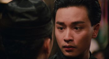 Movie still from “Rouge” (1987), directed by Stanley Kwan – A man looking into a mirror while another man looks on; Close Up shot, Over the shoulder angle