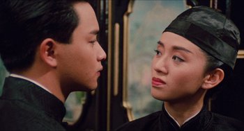Movie still from “Rouge” (1987), directed by Stanley Kwan – A man and a woman looking at one another in front of a mirror; Close Up shot, Over the shoulder angle